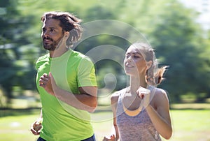 Healthy, fit and sportive couple running in park