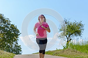 Healthy fit woman enjoying a jog in sunshine