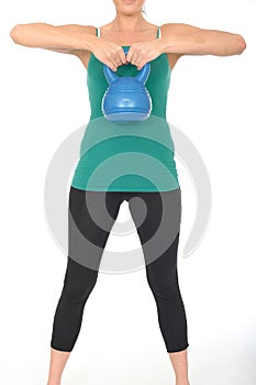 Healthy Fit Young Woman Lifting a 5kg Kettle Bell Weight