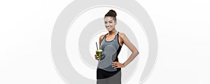 Healthy and Fitness concept - beautiful African American girl in sport clothes holding plastic water bottle after