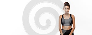Healthy and Fitness concept - Beautiful American African lady in fitness clothes ready for workout.  on white