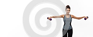 Healthy and Fitness concept - Beautiful American African lady in fitness clothes workout with dumbbell. Isolated on