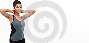 Healthy and Fitness concept - portrait of African American girl posing with fitness clothes over white studio background