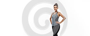 Healthy and Fitness concept - portrait of African American girl posing with fitness clothes over white studio background