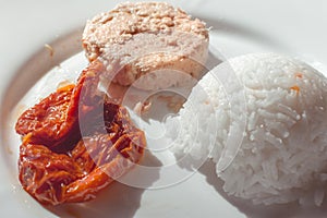 Healthy fitness diet. Rice, tuna and sliced tomatoes.