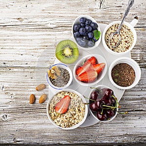 Healthy fitness food from fresh fruits, berries, greens, super food: kinoa, chia seeds, flax seed, strawberry, blueberry