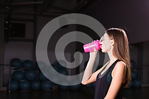 Healthy fitness girl with protein shake. sport and work out girl in gym