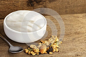 Healthy flavored yogurt in ceramic bowl with cereal and granola