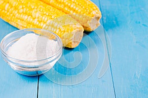 Healthy food. Appetizing boiled corn with salt on a blue background. Copy space