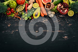 Healthy food background. Concept of Healthy Food, Fresh Vegetables, Nuts and Fruits. On a wooden background.