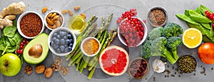 Healthy food background with fresh salmon fish, vegetables, berries and nuts. Top view. Banner