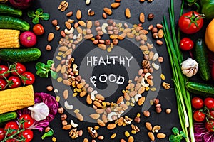 Healthy food background. Healthy food concept with fresh vegetables for cooking and some kind types of nuts.