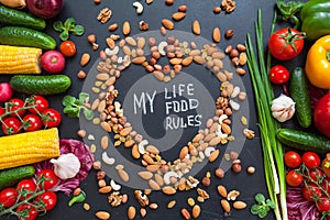 Healthy food background. Healthy food concept with fresh vegetables for cooking and some kind types of nuts. The phrase `My life,