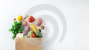 Healthy food background. Healthy vegan vegetarian food in paper bag vegetables and fruits on white, copy space, banner