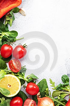 Healthy food background with various green herbs and vred egetables. Ingredients for cooking salad. Top view, copy space