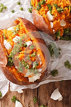 Healthy food: baked sweet potato stuffed with cheese and parsley