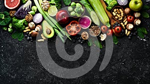 Healthy food banner. Set of fruits, vegetables, nuts, mushrooms and berries. On a black stone background.