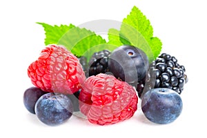 Healthy food berries set. Macro shot of fresh raspberries, blueberries and blackberries with leaf isolated on white background