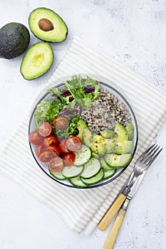 Healthy food. budha bowl with quinoa, avocado, cucumber, salad, tomatoe, olive oil. Clean eating, diet food. Bright background