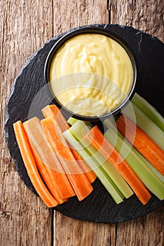 Healthy food: cheese cream sauce dip with fresh vegetables close