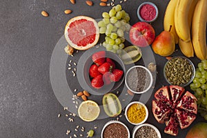 Healthy food clean eating selection: fruit, vegetable, seeds, superfood, cereals, leaf vegetable.