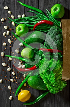 Healthy food clean eating selection: fruit, vegetable, seeds, superfood, cereals, leaf vegetable on gray concrete background
