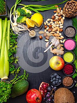 Healthy food clean eating selection in wooden background fruit, vegetable, seeds, superfood, cereals, leaf vegetable on gray