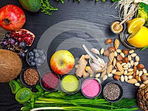 Healthy food clean eating selection in wooden background fruit, vegetable, seeds, superfood, cereals, leaf vegetable on gray