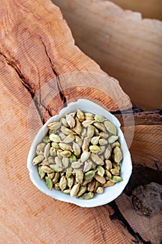 Healthy Food concept Aroma Spice dried Cardamoms on wood background