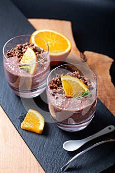 Healthy food concept Chia chocolate orange pudding with granola and pumpkins seed topping in the glasses