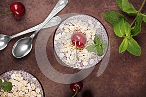 Healthy food concept. Dessert with oatmeal and chia seeds garnished with cherries