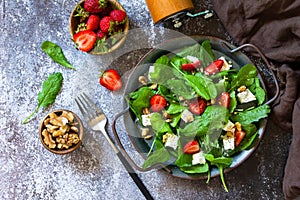 Healthy food concept, Diet salad plate. Summer salad with strawberries, fetacheese and walnut