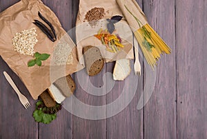 Healthy food concept - Eco bags with products rich of complex carbohedrates: cereals, bread, pasta and greenery