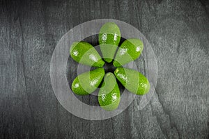 Healthy food concept. Fresh organic avocado. Avocado on dark wooden table, top view, copy space.