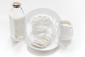 Healthy food concept with milk and cottage cheese on white table