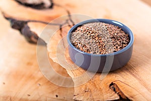Healthy food concept Organic Flax seeds in ceramic bolw on wooden board with copy space