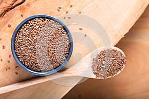 Healthy food concept Organic Flax seeds in ceramic bolw on wooden board with copy space