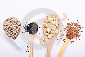 Healthy food concept top view sunflower seeds, cashew nuts, black sesame and flax seeds