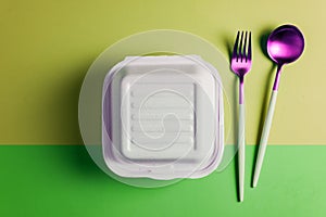 Healthy food concept: white burguer packaging closed with retro fork and spoon photo