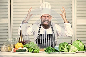 Healthy food cooking. Mature hipster with beard. Vegetarian salad with fresh vegetables. Dieting organic food. Cuisine