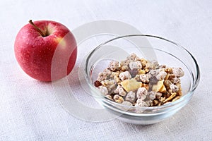 Healthy food with Corn Flakes cereal in a bowl, apple, banana and glass with milk. Morning breakfast.