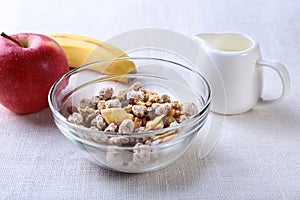 Healthy food with Corn Flakes cereal in a bowl, apple, banana and glass with milk. Morning breakfast.