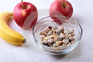 Healthy food with Corn Flakes cereal in a bowl, apple, banana and glass with milk. Morning breakfast.