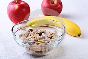 Healthy food with Corn Flakes cereal in a bowl, apple, banana and glass with milk. Morning breakfast.