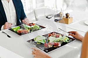 Healthy Food. Couple Eating Caesar Salad For Meal In Restaurant.