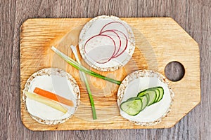Healthy food - cucumber, radish and carrot slices with sour crea
