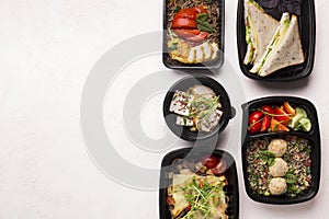 Healthy food delivery in black boxes to go on white