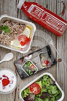 Healthy food delivery. Concept: Proper nutrition, catering, business lunch. Smartphone, wholesome food, disposable