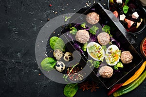 Healthy food and diet concept. Meat balls with egg and vegetables. restaurant dish delivery. Top view.