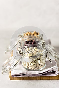 Healthy Food Dieting Nutrition Concept Vegan Protein Source Jars with Kidney Beans and Chickpeas Gray BackgroundVertical